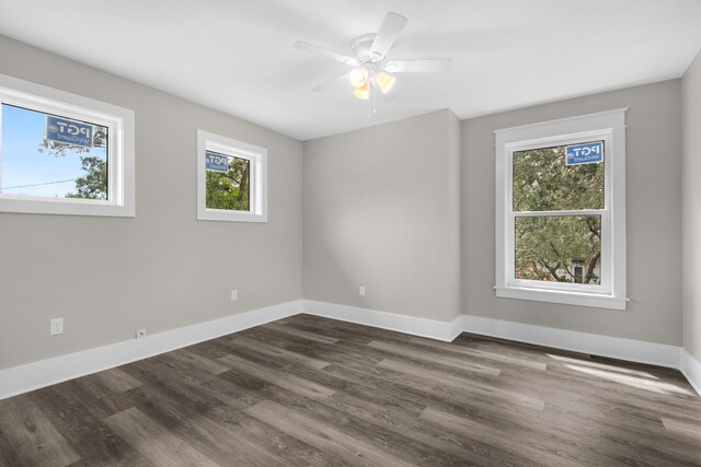 empty room with ceiling fan and dark hardwood / wood-style floors