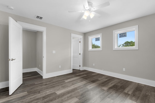 unfurnished bedroom featuring dark wood-type flooring and ceiling fan