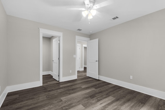 unfurnished bedroom featuring dark hardwood / wood-style flooring and ceiling fan