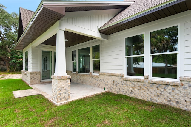 exterior space featuring a lawn and a patio area