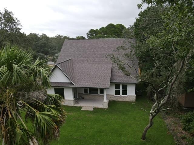 601 Third Ave, Destin, FL 32541 - view of front facade featuring a front lawn, a patio area, and a shingled roof