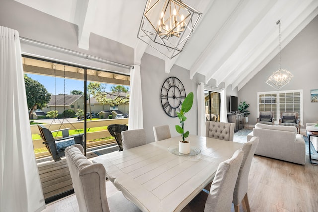 dining room featuring high vaulted ceiling, a chandelier, light hardwood / wood-style flooring, and beam ceiling