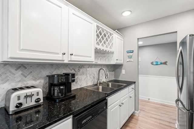 kitchen with stainless steel fridge, sink, black dishwasher, white cabinets, and light hardwood / wood-style floors