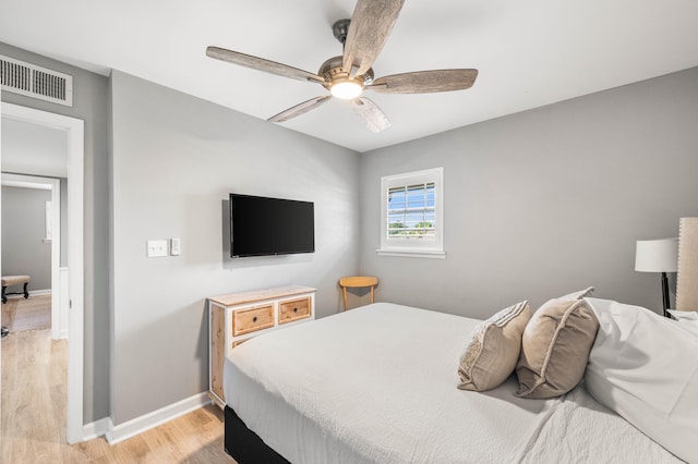 bedroom with ceiling fan and light hardwood / wood-style floors