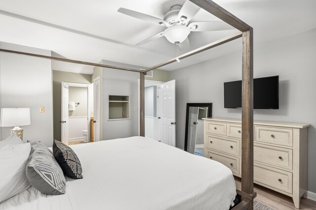 bedroom with ensuite bathroom, ceiling fan, and light hardwood / wood-style floors