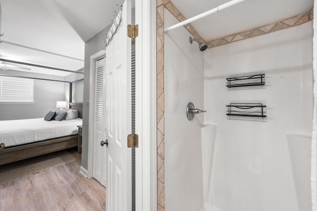 bathroom with a shower and hardwood / wood-style floors