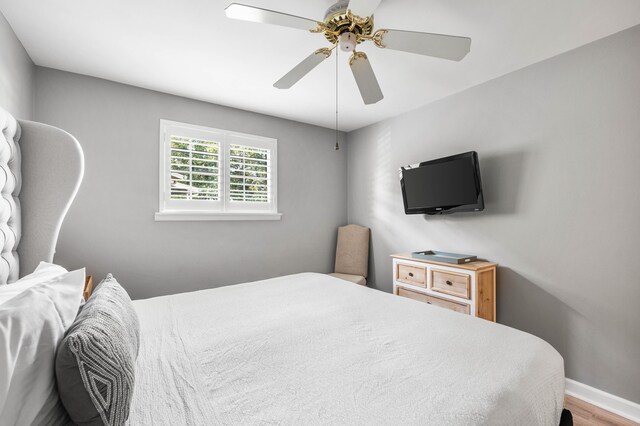 bedroom with ceiling fan and hardwood / wood-style flooring