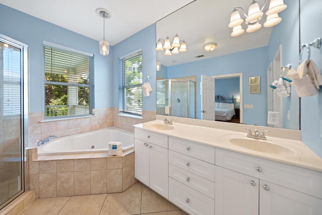 ensuite bathroom with tile patterned flooring, a stall shower, ensuite bathroom, and a sink