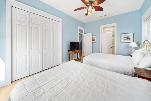 tiled bedroom featuring a closet, visible vents, and a ceiling fan