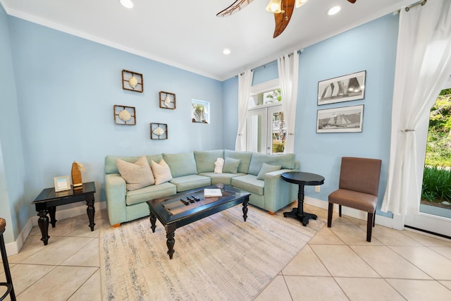 living room with light tile patterned floors, baseboards, and a ceiling fan