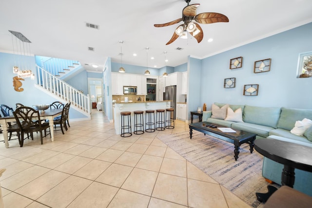 living room with visible vents, a ceiling fan, recessed lighting, light tile patterned flooring, and stairs