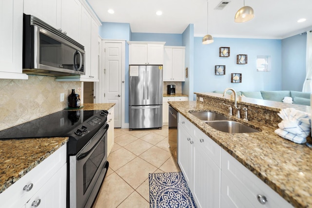 kitchen featuring a sink, stainless steel appliances, white cabinets, and light tile patterned floors