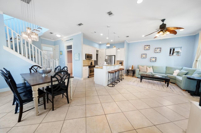 dining room featuring stairway, light tile patterned flooring, and ornamental molding