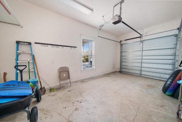 garage with baseboards and a garage door opener