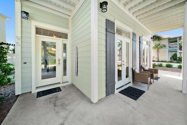 view of exterior entry with french doors and covered porch