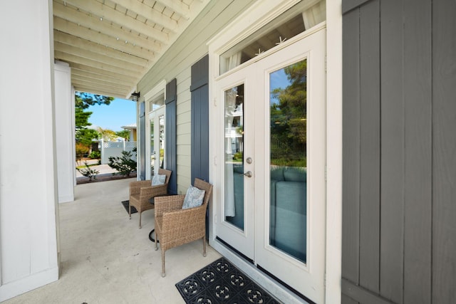 property entrance featuring a porch and french doors