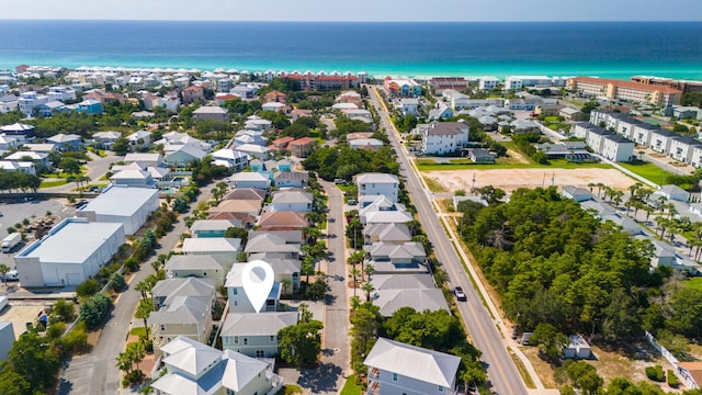 drone / aerial view featuring a residential view and a water view