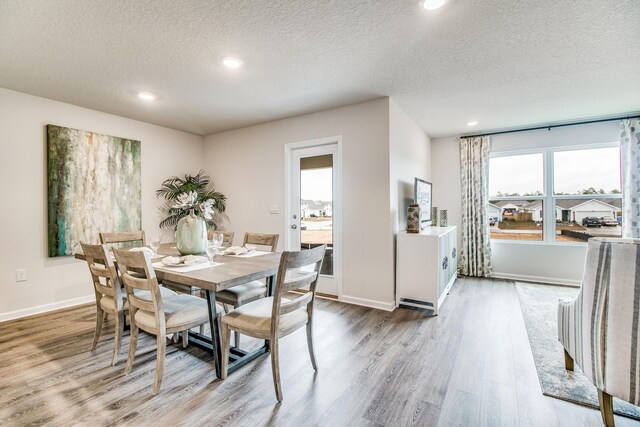 6324 Firefly Dr, Milton, FL 32583 - dining area featuring wood finished floors, a textured ceiling, recessed lighting, and baseboards
