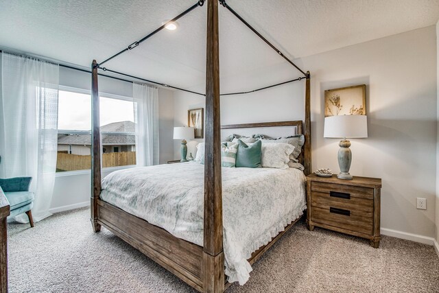 6324 Firefly Dr, Milton, FL 32583 - bedroom with carpet floors, baseboards, and a textured ceiling