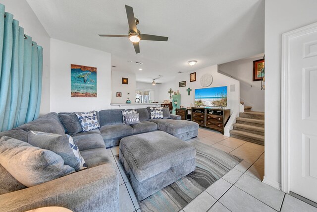 living room with light tile patterned floors and ceiling fan