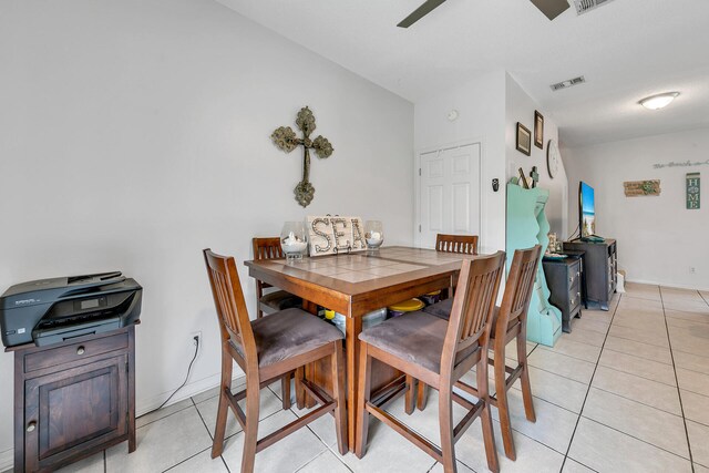 tiled dining area featuring ceiling fan