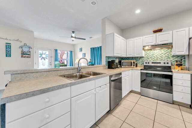 kitchen featuring white cabinetry, kitchen peninsula, stainless steel appliances, ceiling fan, and sink