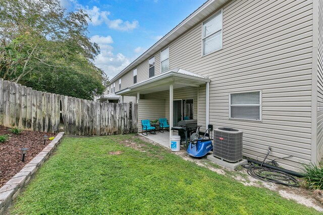 exterior space featuring central AC unit, a yard, and a patio area