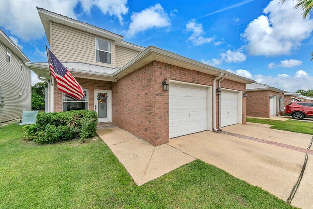 view of front of property with a front lawn and a garage