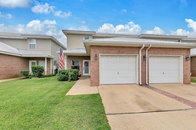 view of front of property featuring a garage and a front lawn