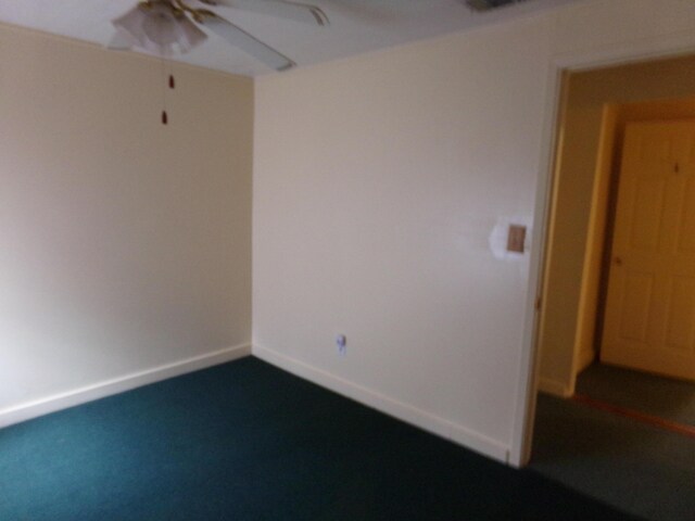 empty room with ceiling fan and carpet