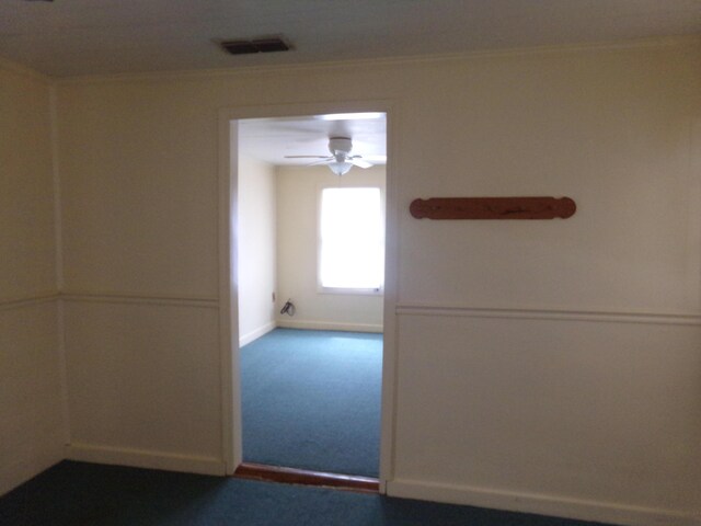 hallway with crown molding and carpet floors