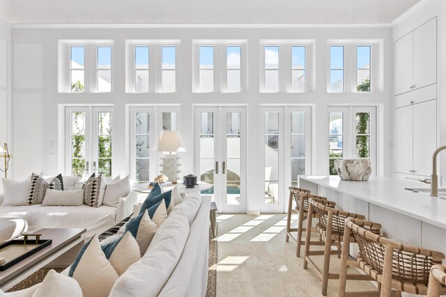 sunroom / solarium featuring french doors and plenty of natural light