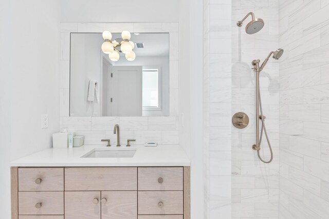 bathroom with vanity and tiled shower