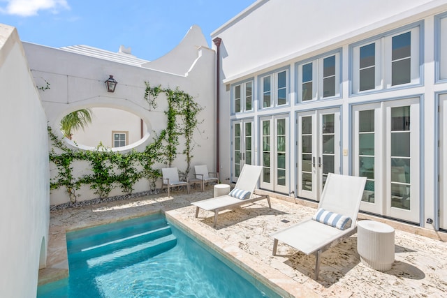 view of pool with french doors