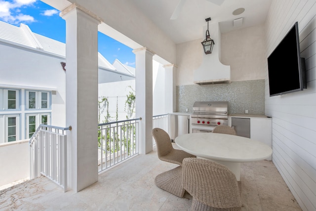 interior space with grilling area, ceiling fan, and exterior kitchen