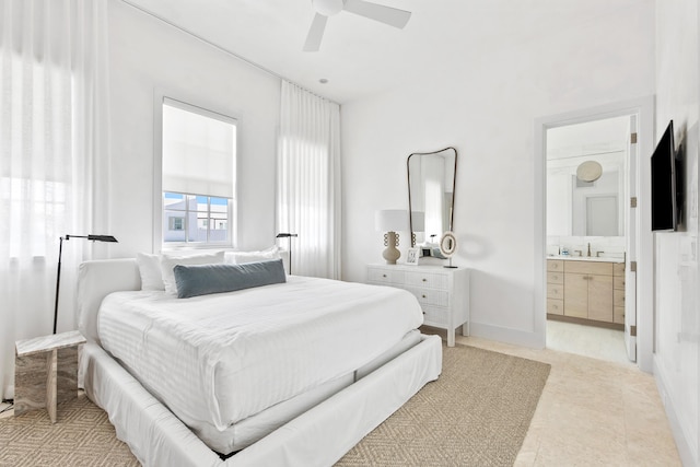 tiled bedroom with ensuite bath and ceiling fan