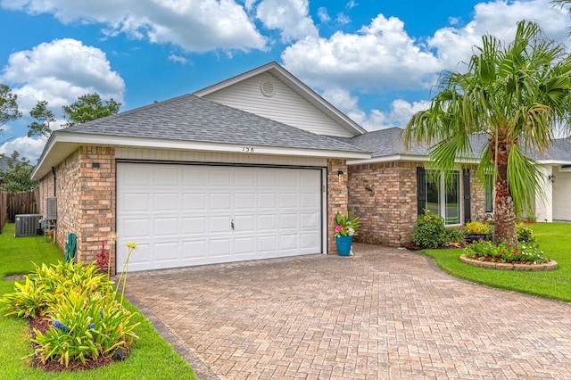 ranch-style home with central AC, a front yard, and a garage