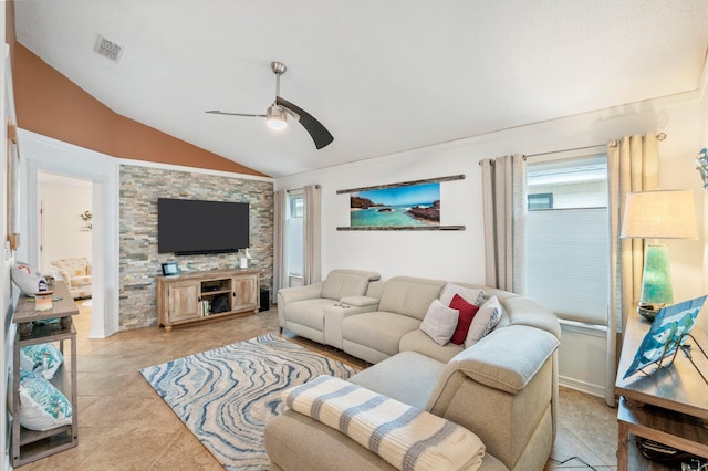 tiled living room with ceiling fan and vaulted ceiling