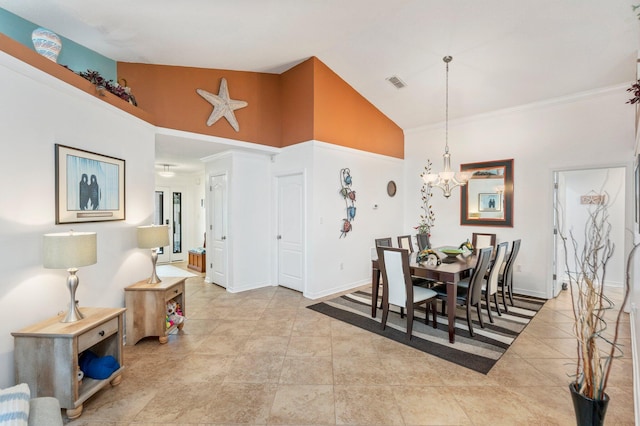 dining area with ornamental molding, high vaulted ceiling, and a notable chandelier