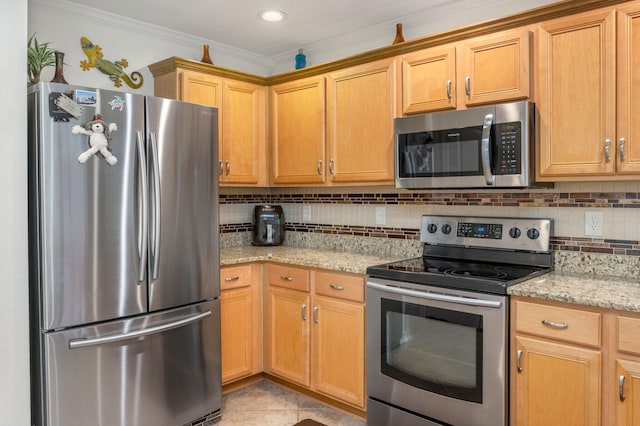 kitchen with ornamental molding, stainless steel appliances, light tile patterned floors, light stone countertops, and decorative backsplash