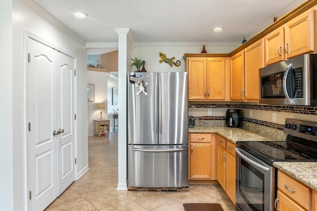 kitchen with stainless steel appliances, light tile patterned floors, crown molding, backsplash, and light stone countertops