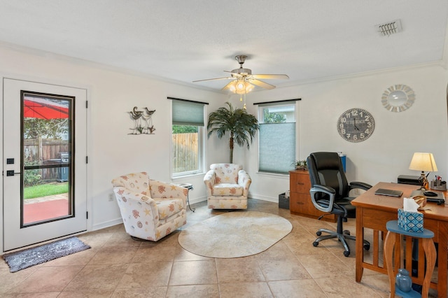 office with a textured ceiling, ceiling fan, crown molding, and light tile patterned floors