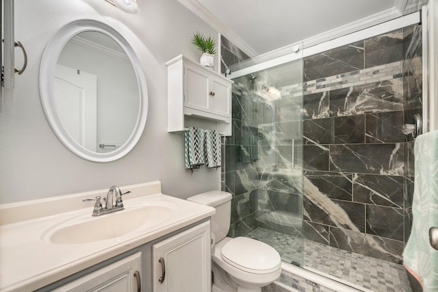 bathroom with toilet, vanity, crown molding, and a shower with shower door