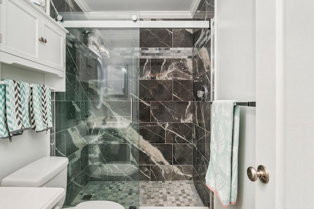 bathroom with toilet, a shower with door, and crown molding