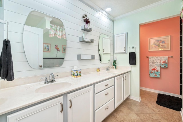 bathroom with vanity, a textured ceiling, tile patterned floors, and crown molding