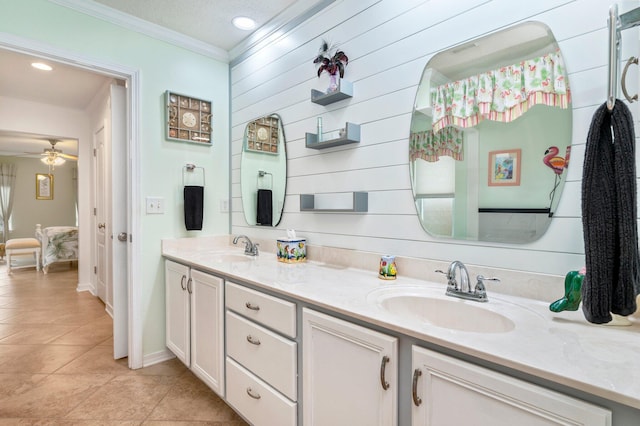 bathroom featuring tile patterned floors, ornamental molding, vanity, a textured ceiling, and ceiling fan