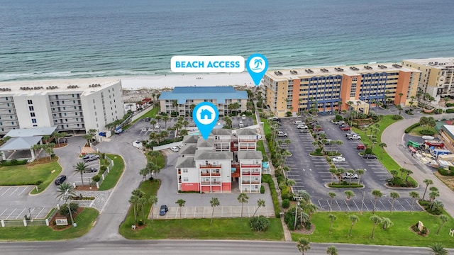 birds eye view of property featuring a water view and a beach view