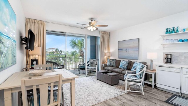 living room with light wood-type flooring and ceiling fan