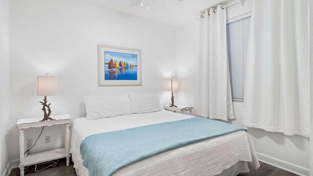 bedroom featuring dark wood-type flooring and ceiling fan