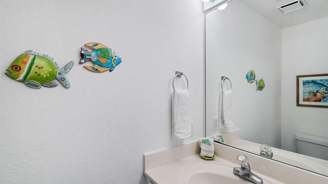 bathroom with vanity and toilet